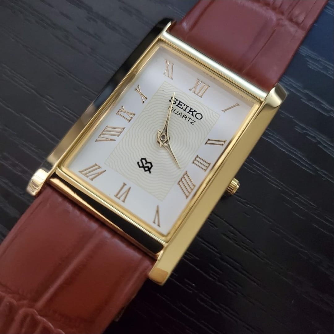 SEIKO SLIM RECTANGULAR WHITE FACE GPLDEN CASE TAN STRAP WATCH 